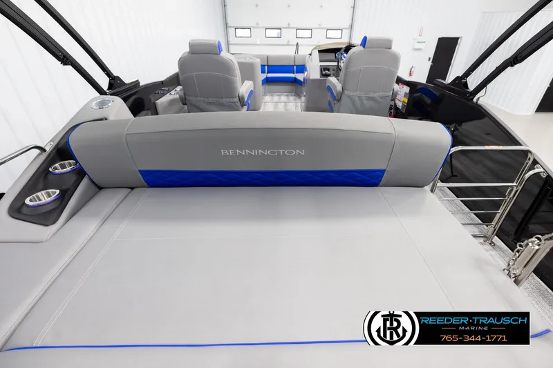 Slide: The Image of 2025 Bennington 25 LTSBSE boat interior with gray and blue seating, cup holders, and logo. - 15