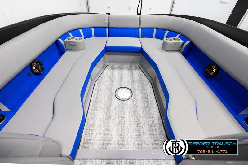 Slide: The Image of 2025 Bennington 25 LTSBSE boat interior with gray and blue seating, speakers, and cup holders. - 17