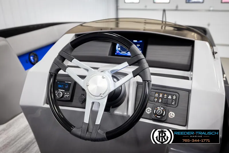 Slide: The Image of 2025 Bennington 25 LTSBSE boat dashboard with steering wheel and control panel. - 23