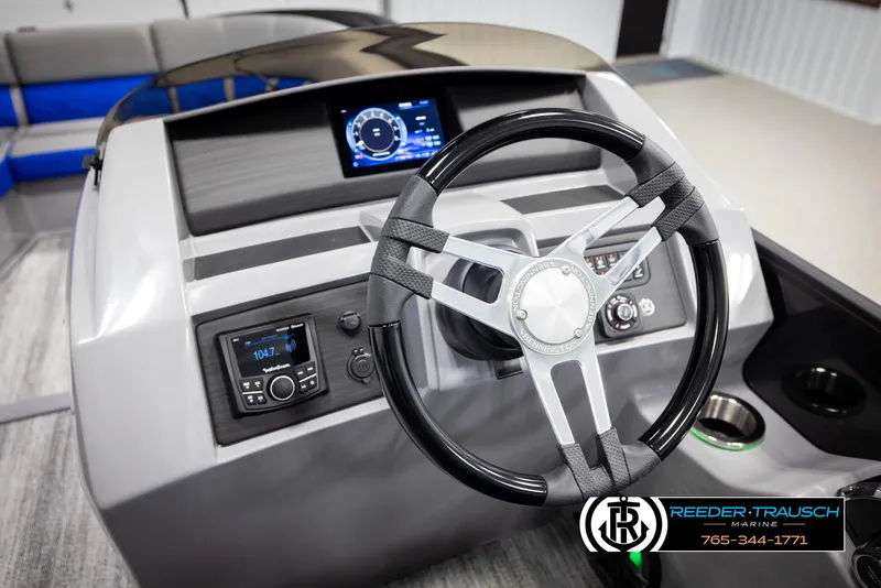 Slide: The Image of 2025 Bennington 25 LTSBSE boat dashboard with steering wheel and digital display. - 24