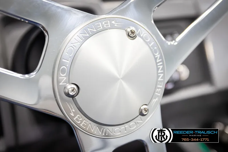 Slide: The Image of Steering wheel of 2025 Bennington 25 LTSBSE boat, featuring sleek metallic design. - 25