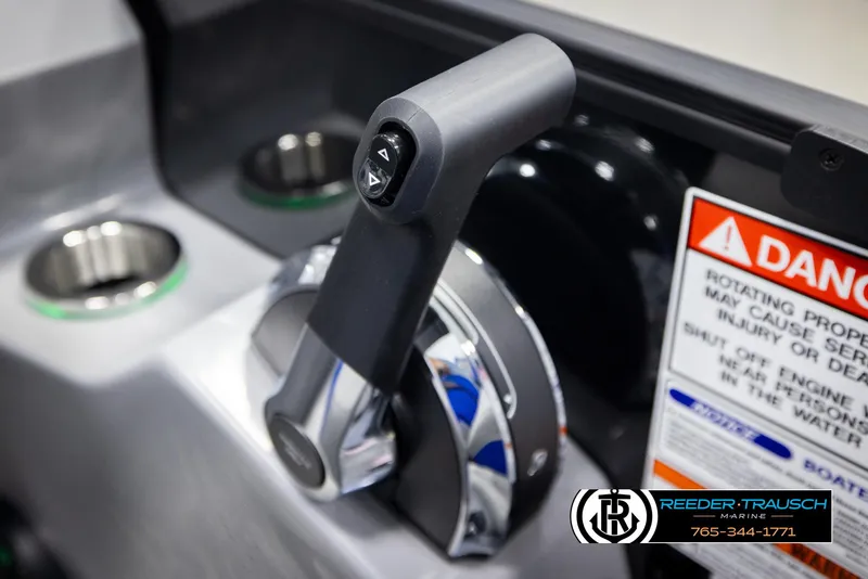 Slide: The Image of Throttle control of 2025 Bennington 25 LTSBSE boat with warning label and cup holders. - 30