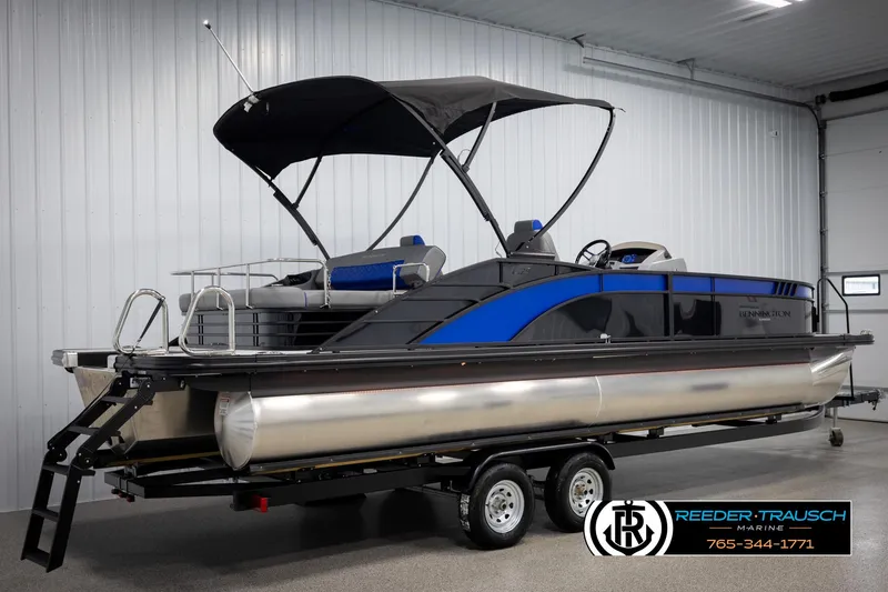 Slide: The Image of 2025 Bennington 25 LTSBSE pontoon boat with canopy on trailer in showroom. - 5