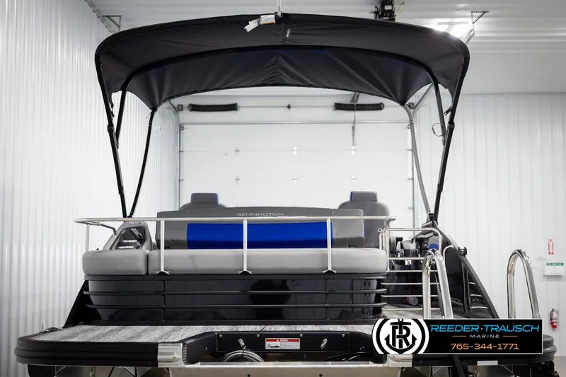 Slide: The Image of 2025 Bennington 25 LTSBSE pontoon boat with canopy in indoor storage. - 6
