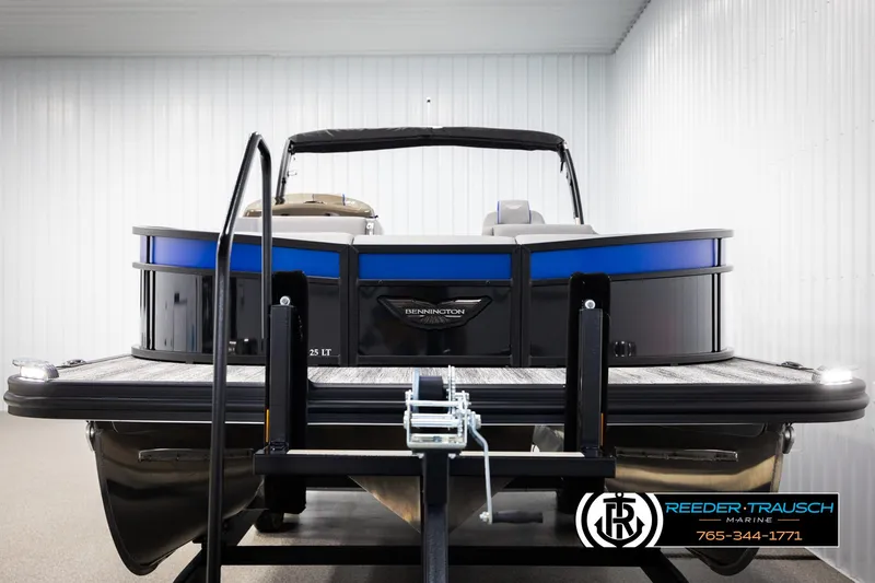 Slide: The Image of 2025 Bennington 25 LTSBSE pontoon boat on trailer in indoor storage. - 7