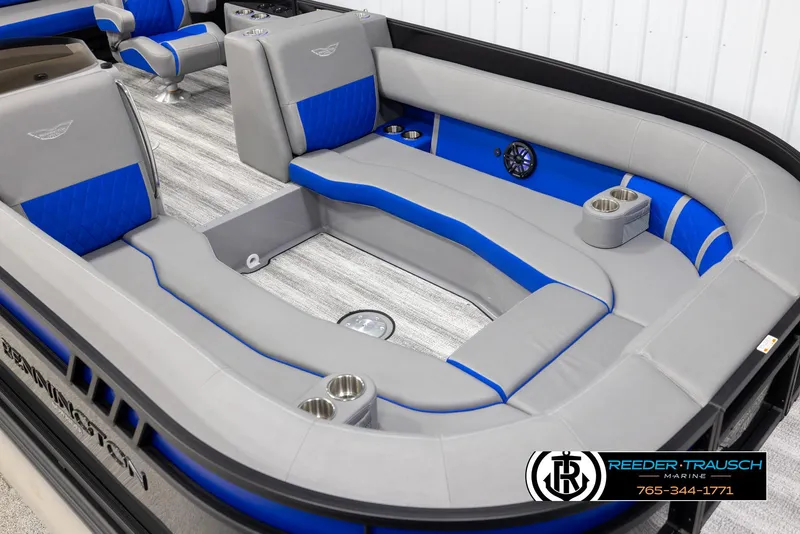 Slide: The Image of 2025 Bennington 25 LTSBSE boat interior with gray and blue seating, cup holders, and logo. - 8