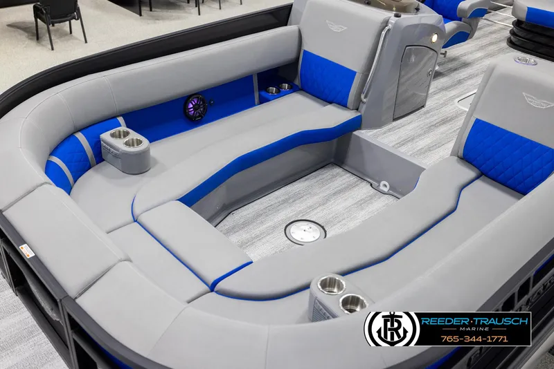 Slide: The Image of 2025 Bennington 25 LTSBSE boat interior with gray and blue seating, cup holders, and speaker. - 9