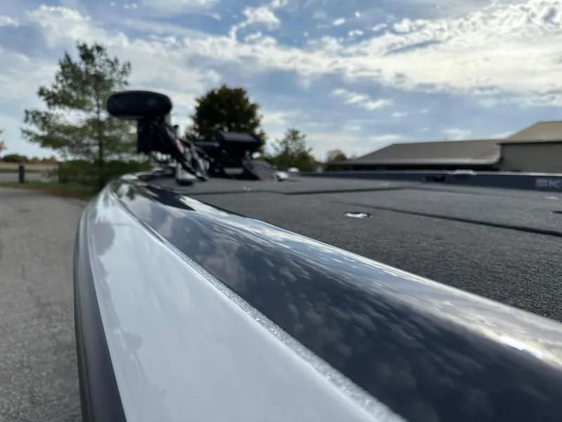 Slide: The Image of 2024 Skeeter ZXR19 boat deck with sleek design under a partly cloudy sky. - 12