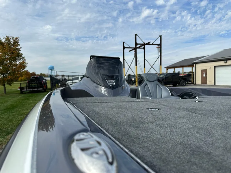 Slide: The Image of 2024 Skeeter ZXR19 boat with sleek design, parked outdoors under a partly cloudy sky. - 16