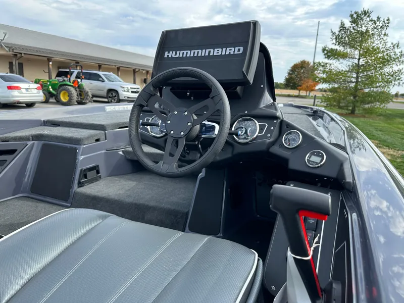 Slide: The Image of 2024 Skeeter ZXR19 boat cockpit with Humminbird electronics and modern steering wheel. - 18