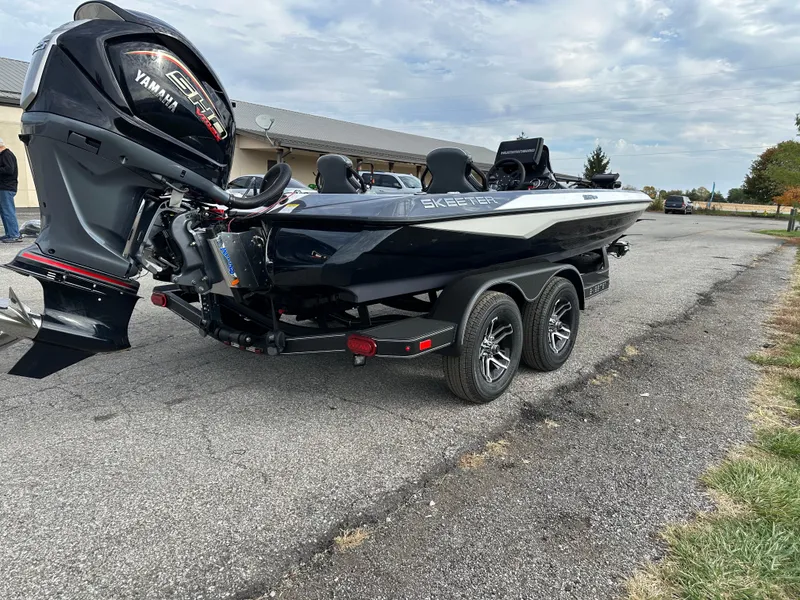 Slide: The Image of 2024 Skeeter ZXR19 boat with Yamaha engine on a trailer, parked outdoors. - 4