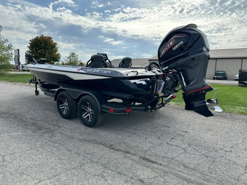 Slide: The Image of 2024 Skeeter ZXR19 boat with Yamaha engine on a trailer, parked outdoors. - 6