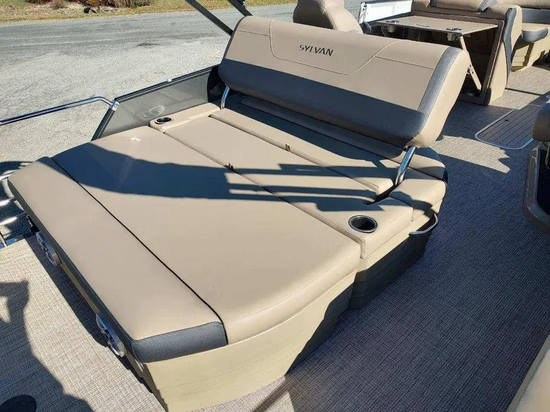 Slide: The Image of 2025 Sylvan X-3 CLZ boat interior with beige seating and cup holders. - 7