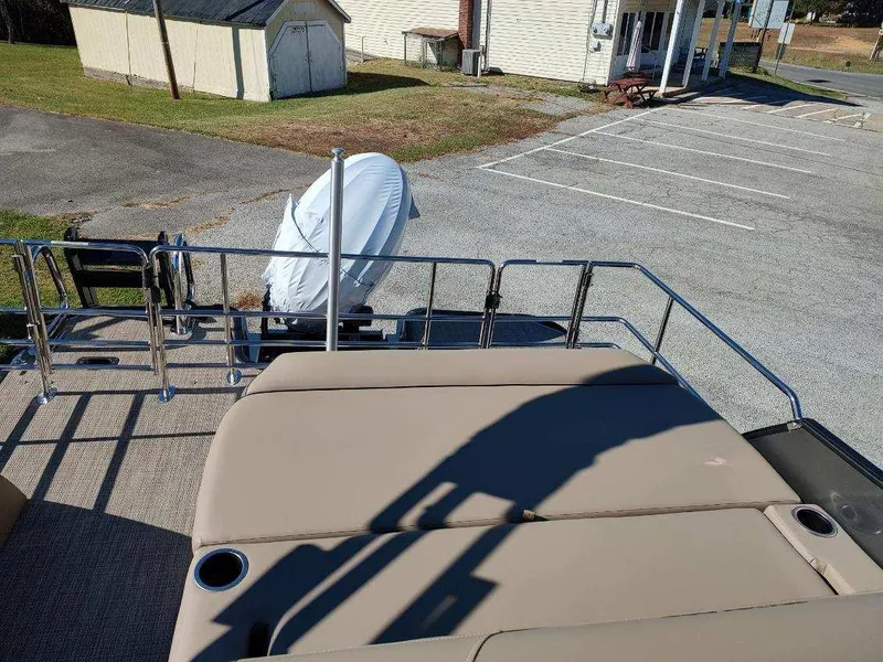 Slide: The Image of 2025 Sylvan X-3 CLZ boat with covered motor, parked in a lot. - 8