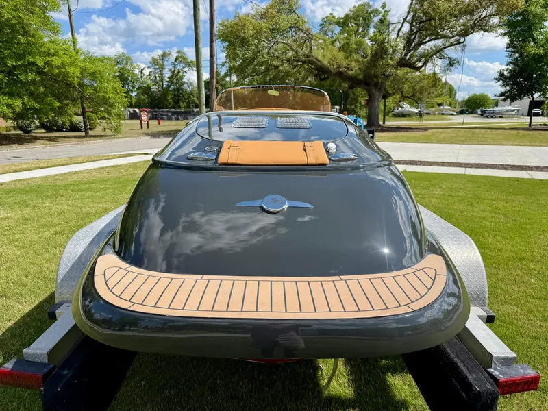 Slide: The Image of 2019 Seven Seas Yachts Hermes Speedster on trailer, sleek design, parked on grass. - 11