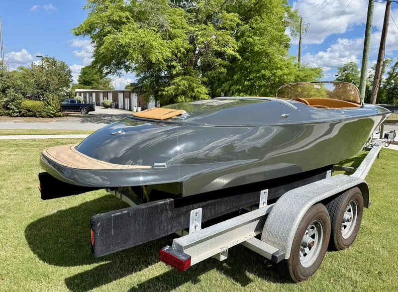 Slide: The Image of 2019 Seven Seas Yachts Hermes Speedster on trailer, sleek design, parked on grass. - 12