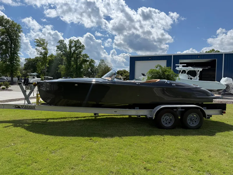 Slide: The Image of 2019 Seven Seas Yachts Hermes Speedster on trailer, parked on grass under a sunny sky. - 13