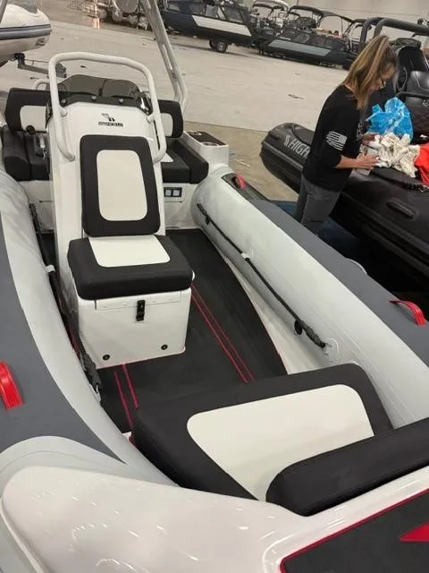 Slide: The Image of 2025 Highfield Velox 420 boat interior with seating and console, displayed indoors. - 11