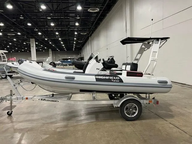 Slide: The Image of 2025 Highfield Velox 420 inflatable boat on trailer in indoor showroom. - 6