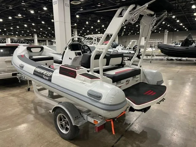 Slide: The Image of Highfield Velox 420 inflatable boat, 2025 model, displayed indoors on a trailer. - 7