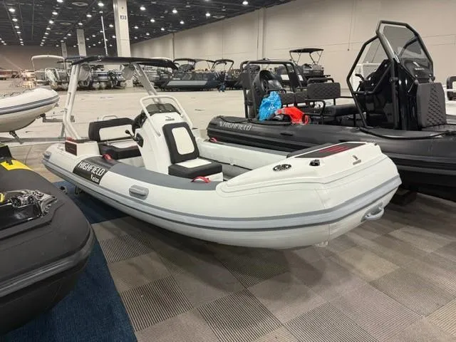 Slide: The Image of 2025 Highfield Velox 420 inflatable boat displayed indoors at a boat show. - 8