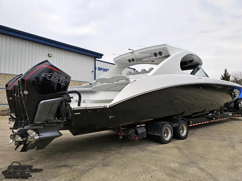 Slide: The Image of 2023 Mystic Powerboats M5200 with powerful engines on a trailer, ready for transport. - 14