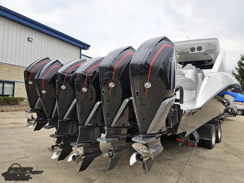 Slide: The Image of 2023 Mystic Powerboats M5200 with five powerful outboard engines, parked on a trailer. - 15