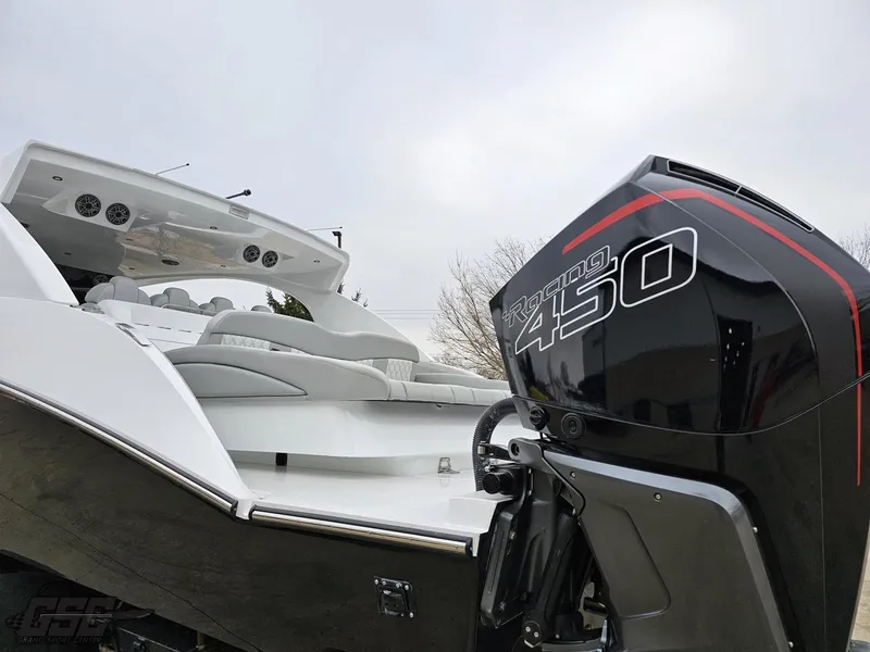 Slide: The Image of 2023 Mystic Powerboats M5200 with powerful 450 engine, sleek design, and luxurious seating. - 17