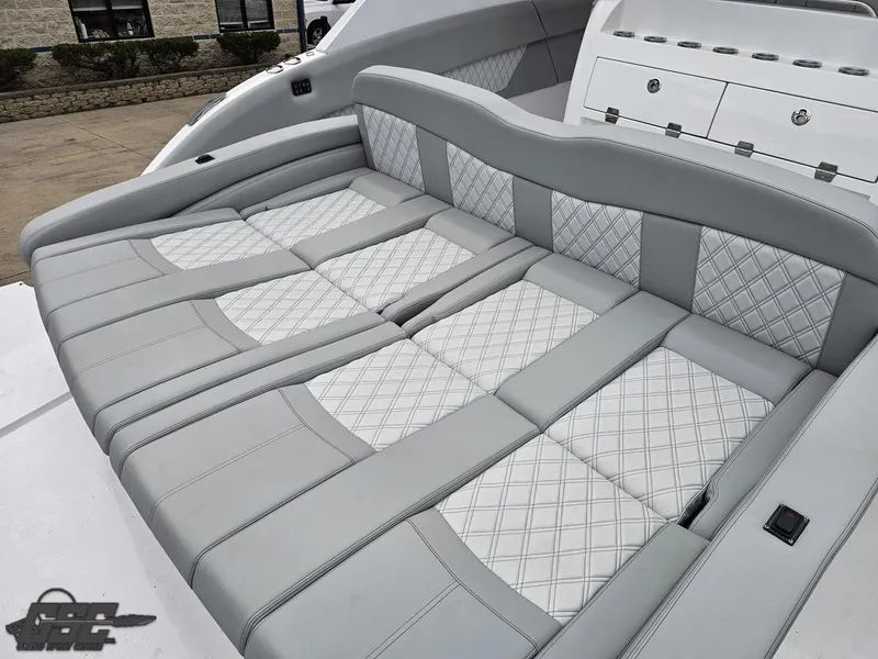 Slide: The Image of Luxurious seating on 2023 Mystic Powerboats M5200 with quilted gray upholstery. - 24