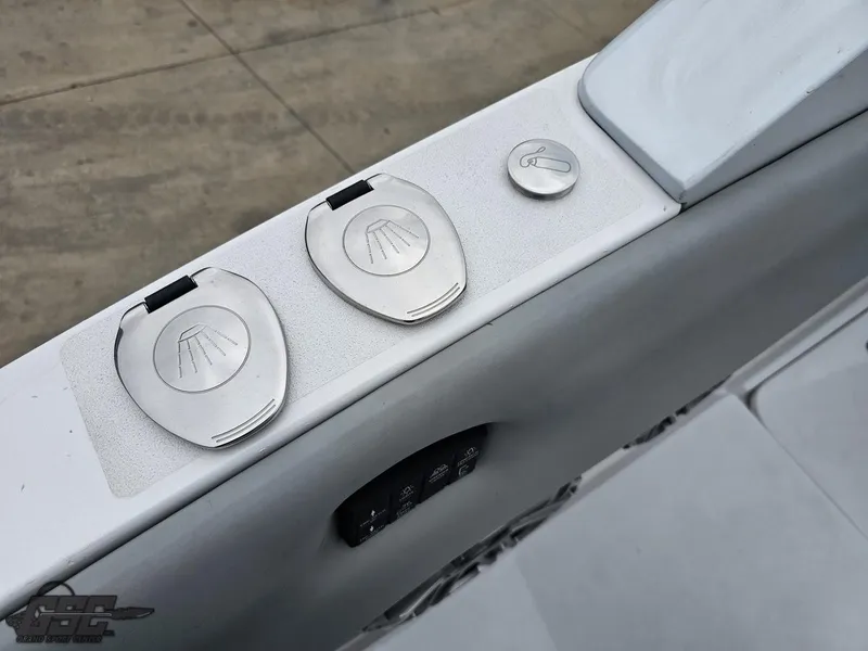 Slide: The Image of 2023 Mystic Powerboats M5200 control panel with sleek metallic switches and buttons. - 29