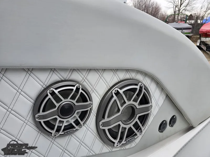 Slide: The Image of 2023 Mystic Powerboats M5200 interior with dual speakers and quilted upholstery. - 32