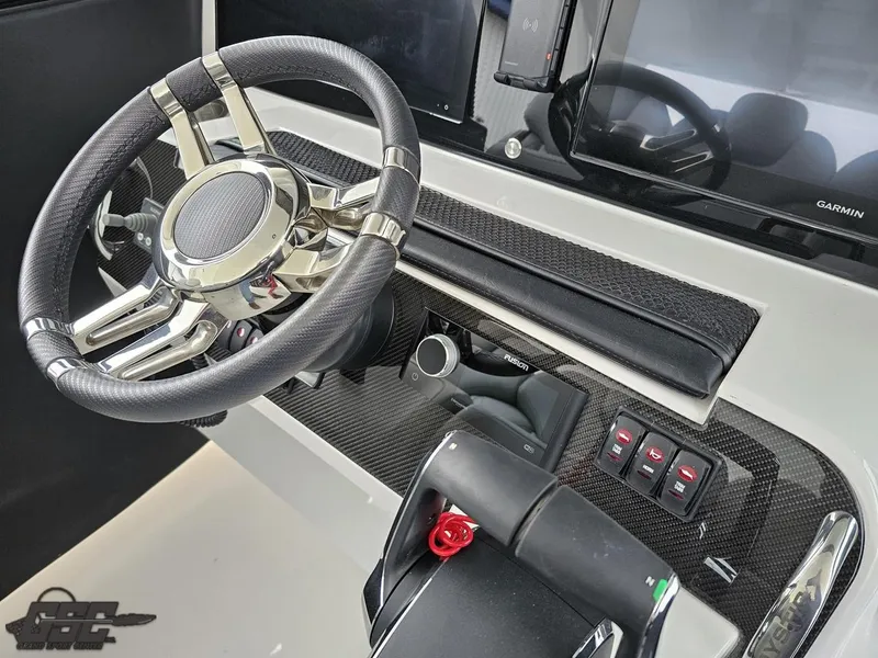 Slide: The Image of 2023 Mystic Powerboats M5200 helm with sleek steering wheel and modern controls. - 38