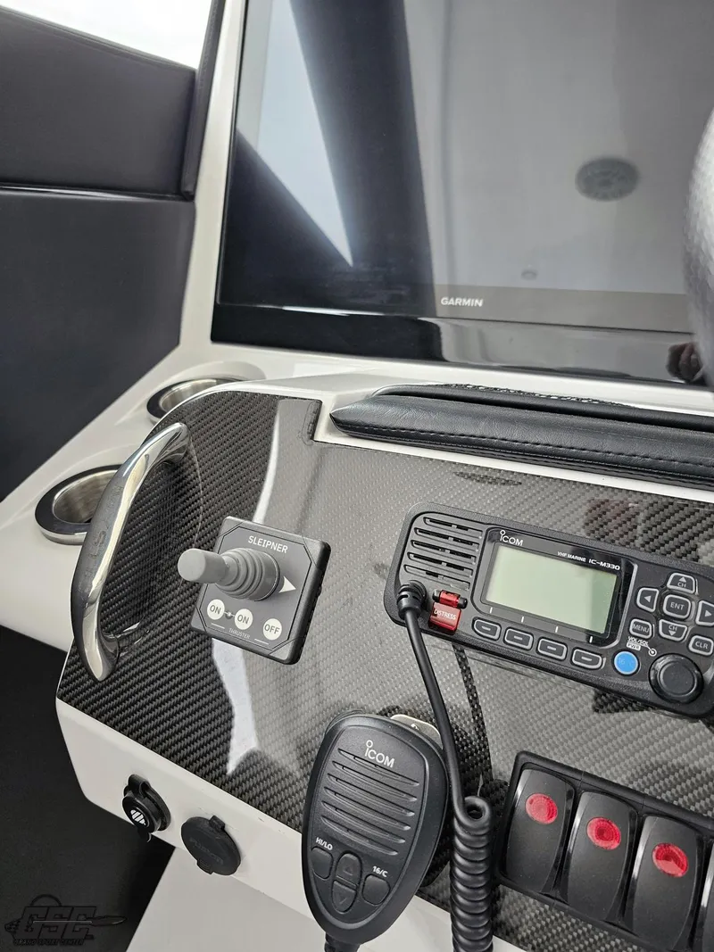 Slide: The Image of 2023 Mystic Powerboats M5200 dashboard with control panel and communication equipment. - 39