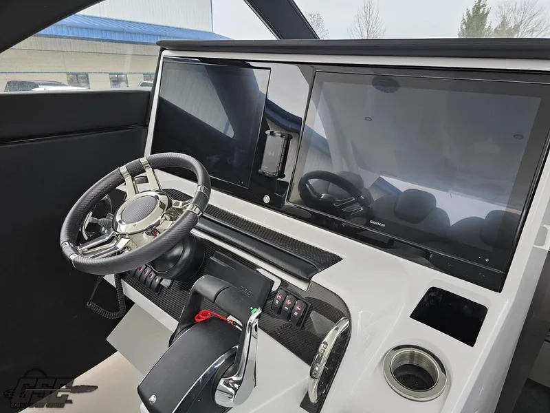 Slide: The Image of 2023 Mystic Powerboats M5200 helm with dual screens and modern steering wheel. - 40