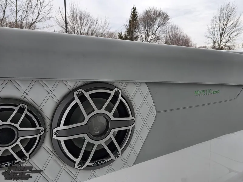 Slide: The Image of 2023 Mystic Powerboats M5200 with JL Audio speakers, featuring sleek design and modern aesthetics. - 42