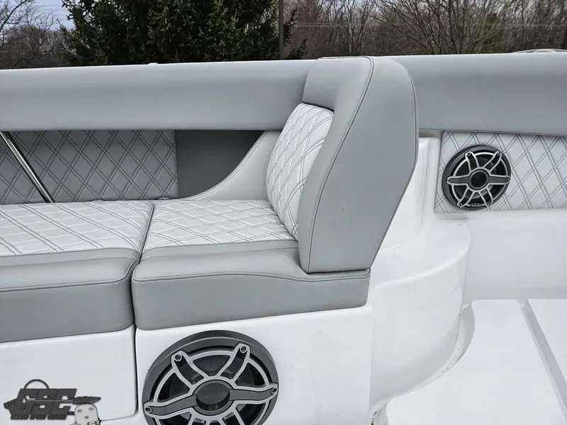 Slide: The Image of 2023 Mystic Powerboats M5200 interior with gray seating and built-in speakers. - 44