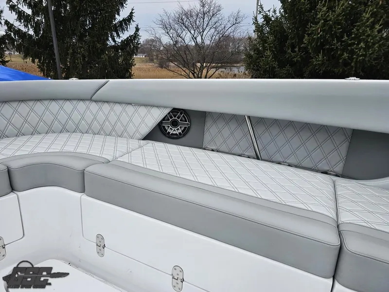 Slide: The Image of 2023 Mystic Powerboats M5200 interior with diamond-stitched seating and speaker detail. - 45