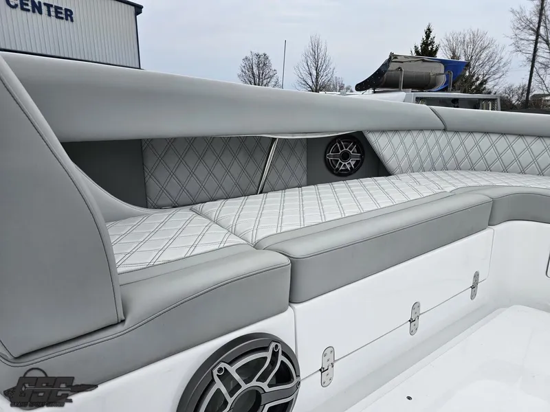 Slide: The Image of 2023 Mystic Powerboats M5200 interior with gray quilted seating and speaker system. - 47