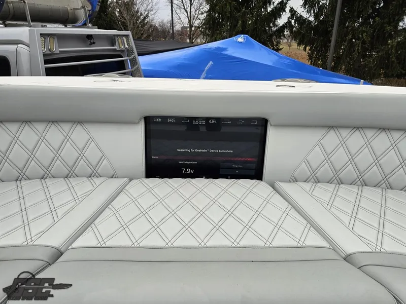 Slide: The Image of Luxurious interior of 2023 Mystic Powerboats M5200 with diamond-stitched seating and digital display. - 48