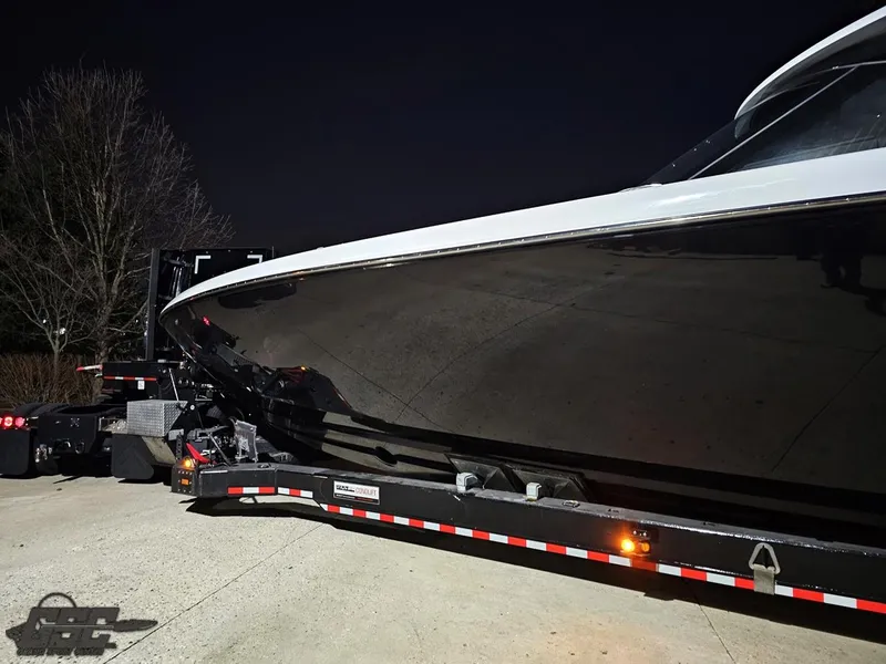 Slide: The Image of 2023 Mystic Powerboats M5200 on trailer at night, sleek black hull. - 7