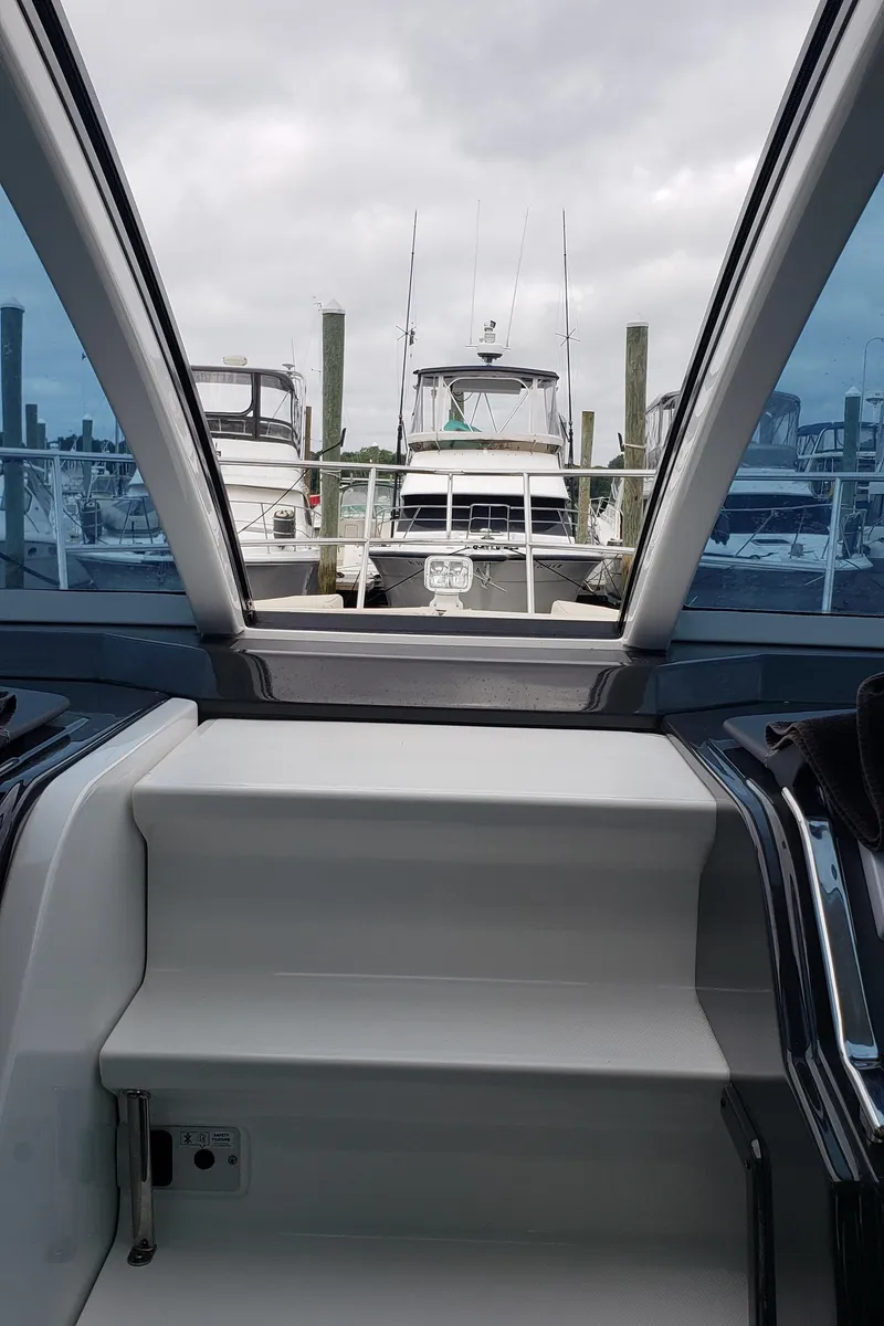 Slide: The Image of 2016 Monterey 360 Sport Coupe interior with marina view through glass roof. - 17