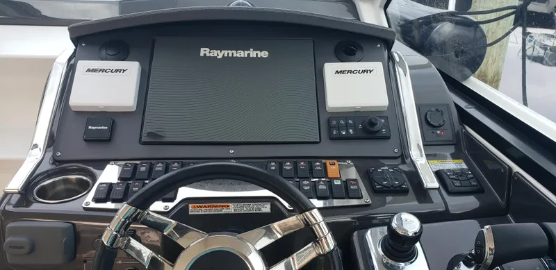 Slide: The Image of Helm of 2016 Monterey 360 Sport Coupe with Raymarine navigation system and Mercury controls. - 22