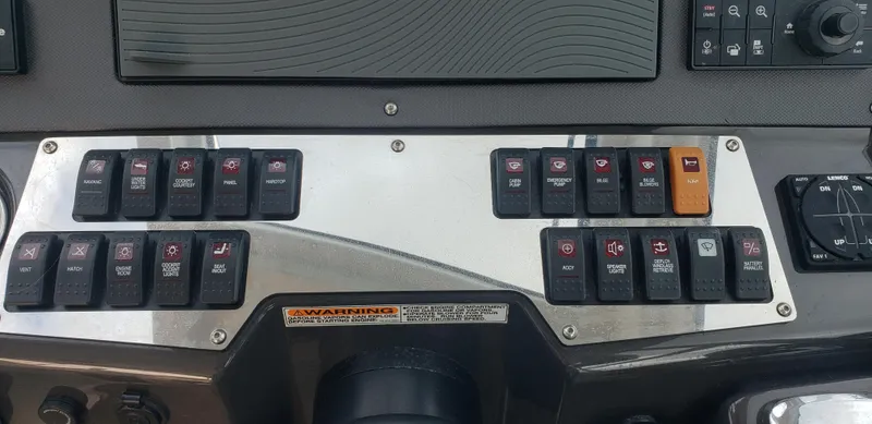 Slide: The Image of Control panel of a 2016 Monterey 360 Sport Coupe boat with various switches and buttons. - 23