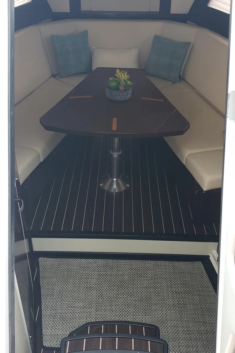 Slide: The Image of 2016 Monterey 360 Sport Coupe interior with elegant seating and wooden table. - 32