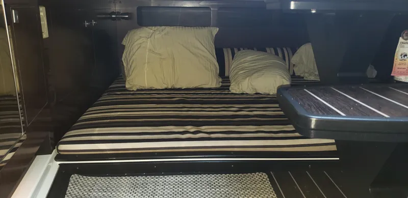 Slide: The Image of Cozy cabin interior of 2016 Monterey 360 Sport Coupe with striped bedding and pillows. - 33