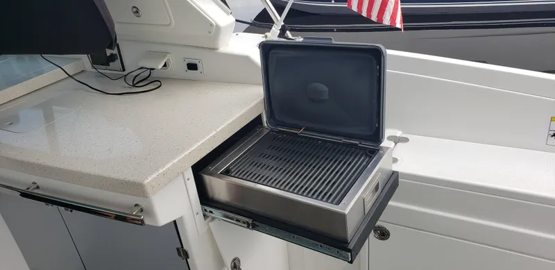 Slide: The Image of Outdoor grill on 2016 Monterey 360 Sport Coupe yacht with American flag. - 9