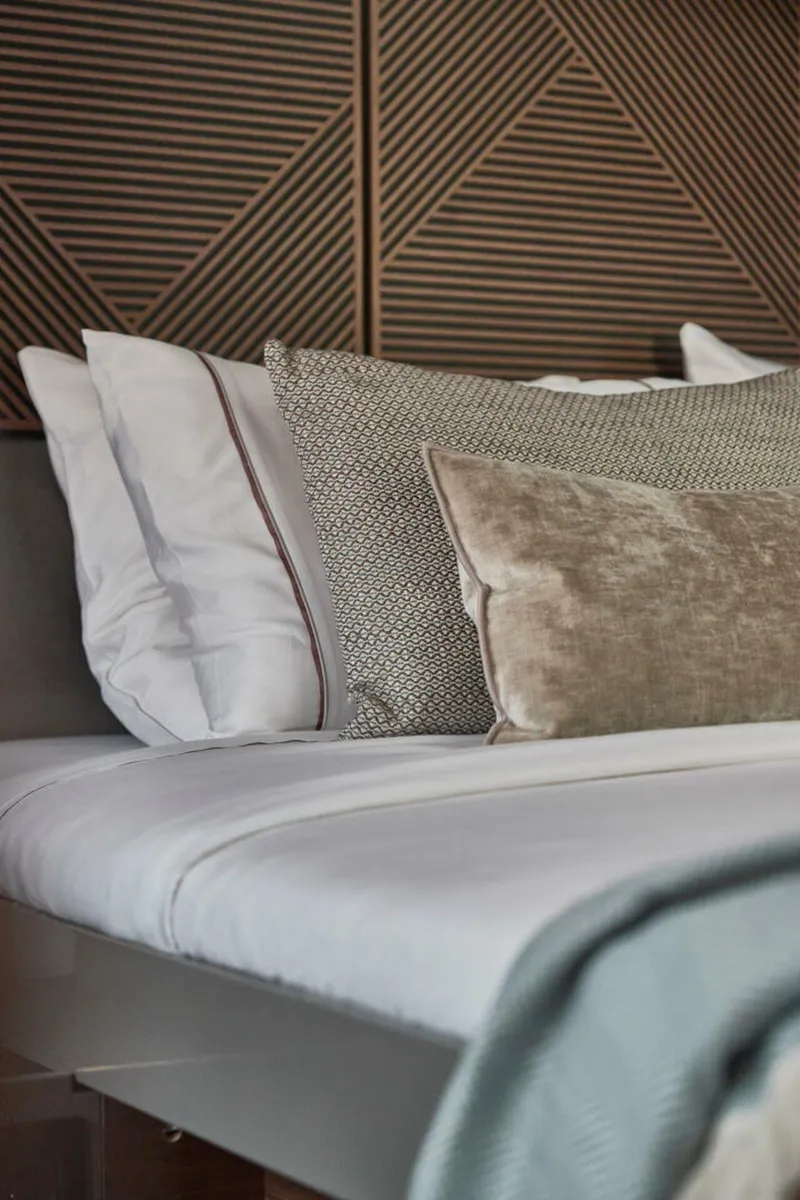 Slide: The Image of Luxurious Prestige M48 2025 yacht bedroom with elegant pillows and geometric wall design. - 13
