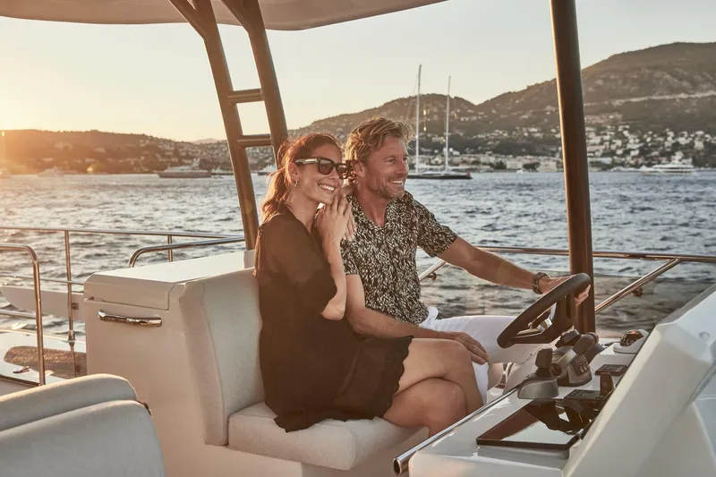 Slide: The Image of Couple enjoying a sunset cruise on a 2025 Prestige M48 yacht. - 16