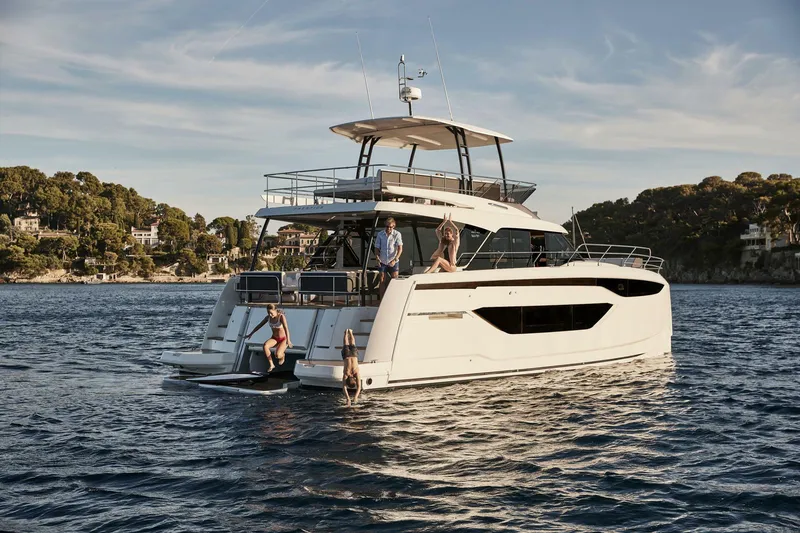 Slide: The Image of 2025 Prestige M48 yacht on serene water with people enjoying the deck. - 21
