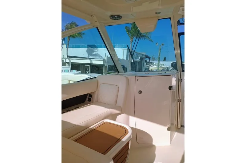 Slide: The Image of Interior of 2025 Grady-White Freedom 345 boat, featuring seating and windows. - 10